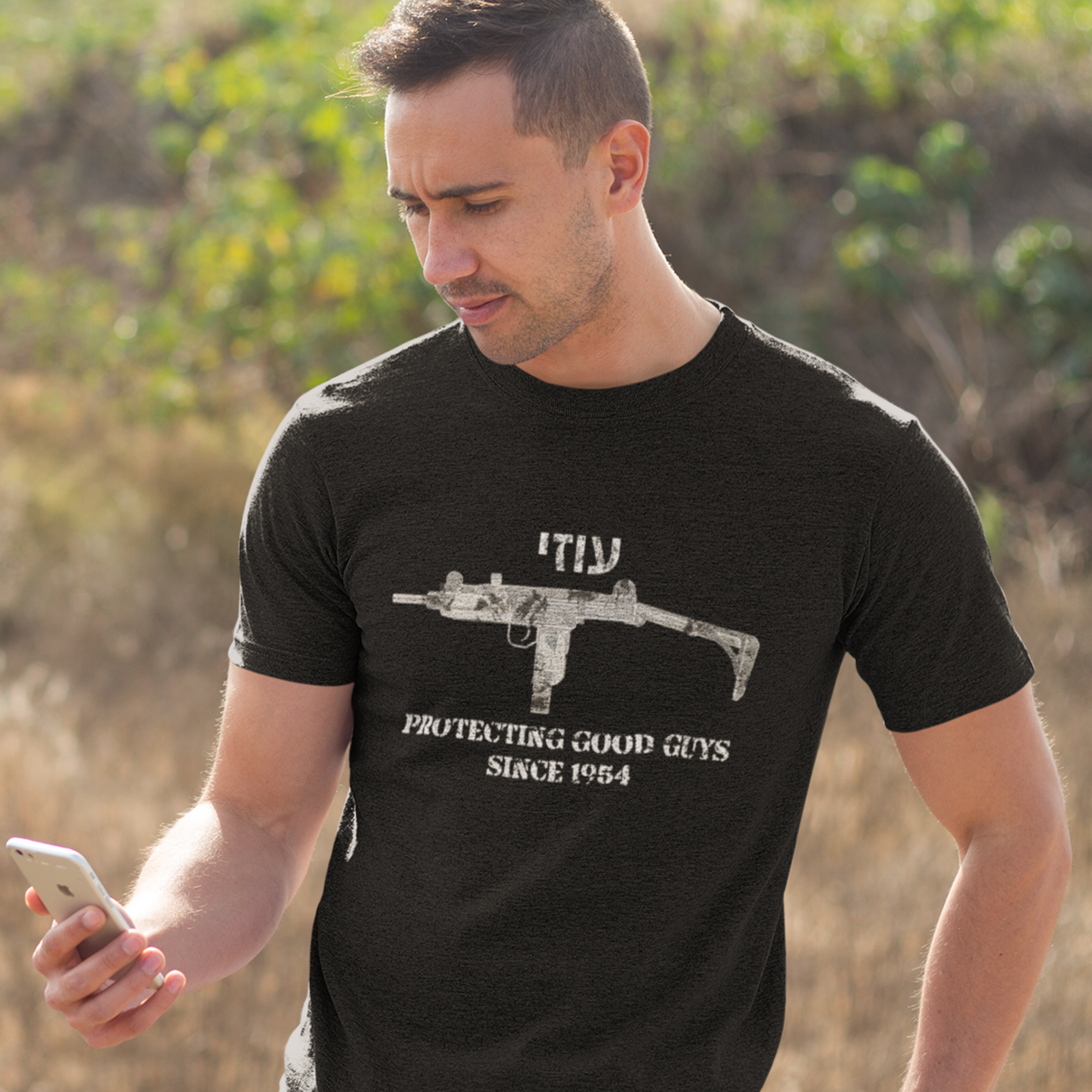 Uzi protecting good guys Unisex Cotton Tee